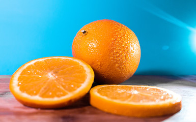 Orange Slices And Orange On Blue Backdrop Lens Flare Yummy Water Droplets