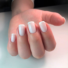 Beautiful woman's nails with beautiful french manicure