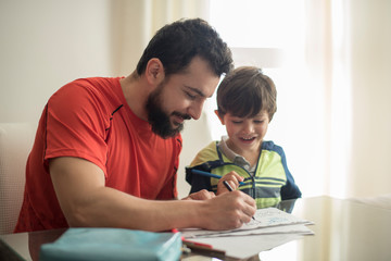 Father helping son doing homework