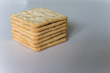 Stack of cream crackers on a white background