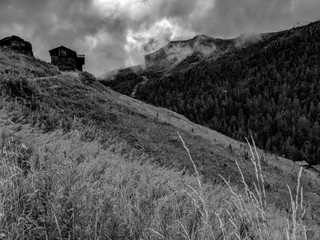 Black and White Photography of Alpine wooden houses in the Swiss Alps.