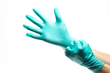 Putting on and stretching protective surgical gloves against white background. Concept of protective measures against corona virus spread. 