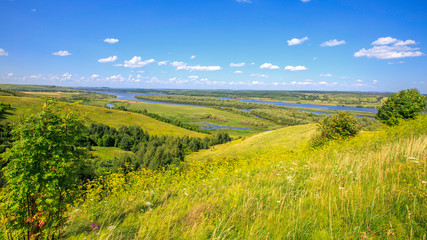 Fototapeta na wymiar beautiful hills on the high bank of the river Vyatka on a sunny day in summer