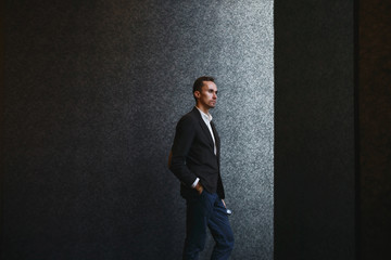 Confident well-dressed man in luxury apartment interior.