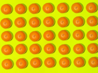 Colorful fruit pattern of fresh mandarins on a light green background. Top view