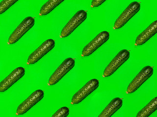 Colorful of fresh pattern cucumber on a green background. Top view