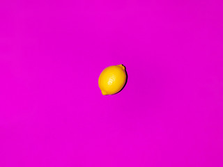 Colorful fruit of fresh lemons on a pink background. Top view