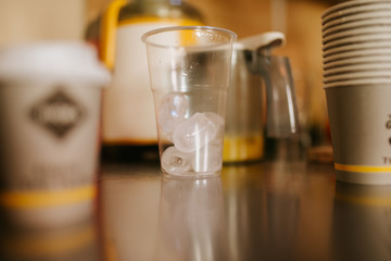 An empty glass of ice on table in cafe