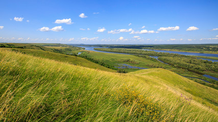 hills overgrown with grass and trees on the banks of the Vyatka River