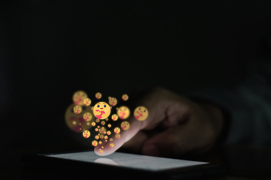 A Young Businessman Touching His Finger On The Screen And Show A New Emoji Showing The Care Reaction Emoji Of Facebook, 
The New Facebook Emoji Concept,Care Emoji