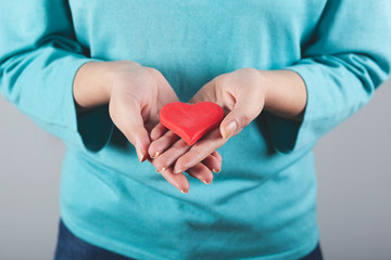 woman hand red heart