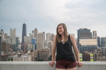 traveler overlooking chicago skyline from rooftop