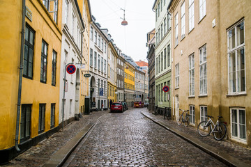 Fototapeta na wymiar colorful townhomes of Copenhagen Denmark along cobblestone street