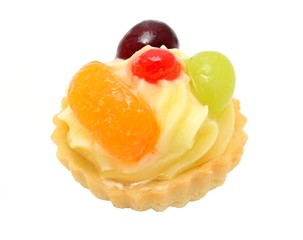 Vanilla cupcake with fruits isolated on white.