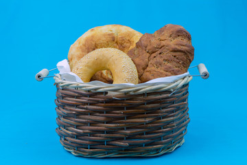 Wicker basket with fresh bread, pita bread and bagel