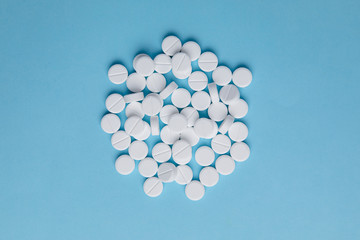 White pills on blue background