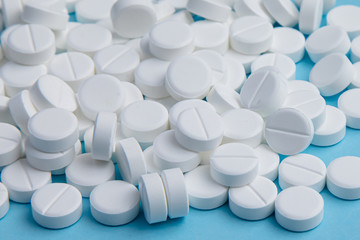 White pills on blue background