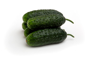 Bright green cucumbers whole isolated on a white background
