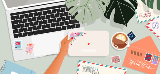 Envelopes, laptop, and postcards on the table. Hands holding an envelope. Top-down view. Greeting card and a letter in a hand. Modern vector illustration for web design and print. 