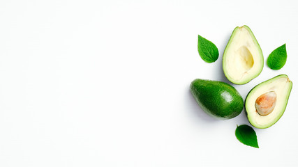 Fresh ripe avocado with green leaves isolated on white background. Top view with copy space.