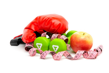 Red Boxing glove, yellow apple and green dumbbells isolated  with Measuring tape on a white background