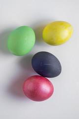 Easter festive multi-colored mother-of-pearl chicken eggs lay on a white background