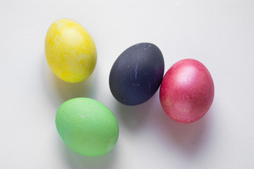 Easter festive multi-colored mother-of-pearl chicken eggs lay on a white background
