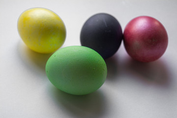 Easter festive multi-colored mother-of-pearl chicken eggs lay on a white background