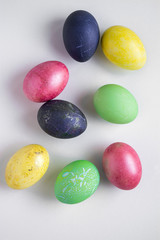 Easter festive multi-colored mother-of-pearl chicken eggs lay on a white background