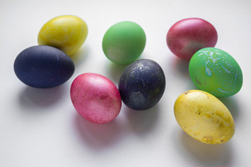 Easter festive multi-colored mother-of-pearl chicken eggs lay on a white background