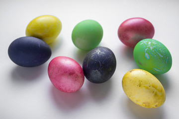 Easter festive multi-colored mother-of-pearl chicken eggs lay on a white background