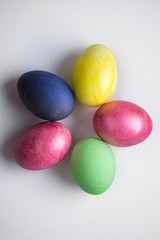 Fototapeta na wymiar Easter festive multi-colored mother-of-pearl chicken eggs lay on a white background