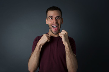 Human face expressions and emotions. Portrait of young desperate man looking panic, holding his hands near his face, with mouth wide open. Male in despair and shock