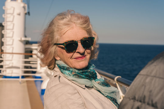 oldies standing outside on the deck of a cruise ship