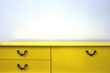 Still life of vintage retro yellow cupboard with white wall, modern design