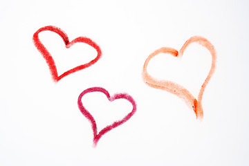 three red hearts drawn with lippstick