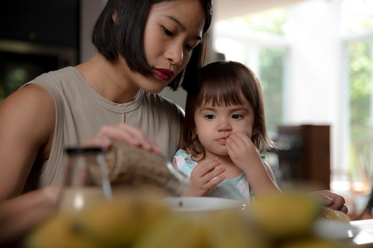 Mom and daughter preparing breakfast together