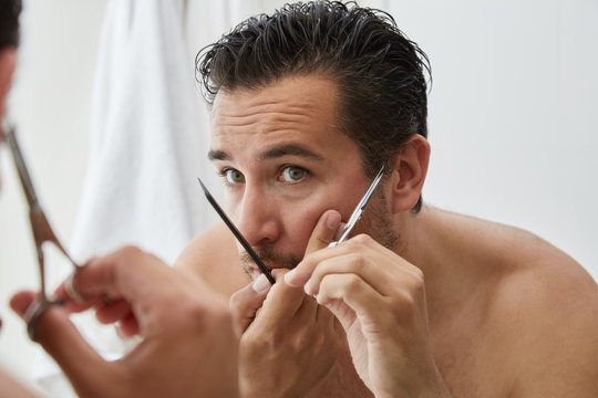 Man trimming sideburns