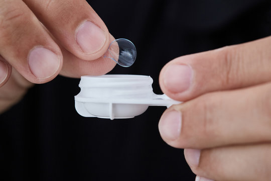 Man inserting contact lens