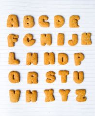 Alphabet shaped cookies on a notebook
