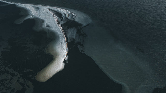 sand bank in dark sea