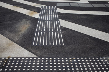 lines on asphalt road with markings for blind people