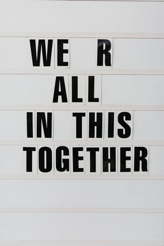 A sign that says ""We R All In This Together""