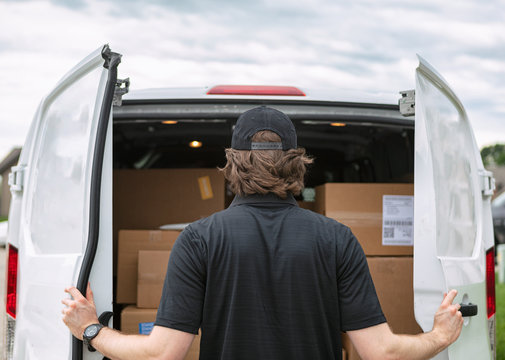 Shipment: Man Opens Rear Doors Of Delivery Van