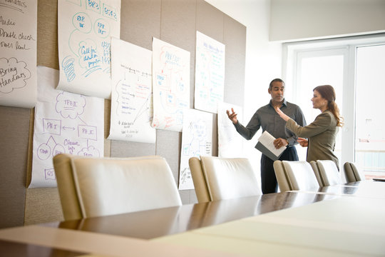 Businessman and businesswoman working in office