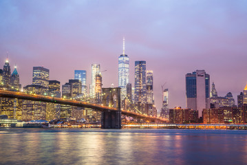 new york city skyline and brooklyn bridge at night