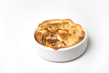 Closeup of mini tartlets in a white plate on white background