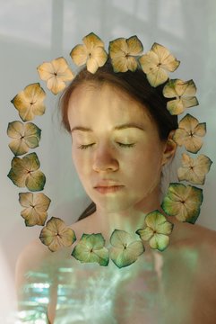 Daydreaming young woman in flower frame