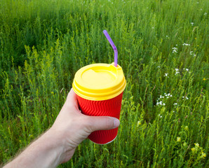 Hand holding plastic cup