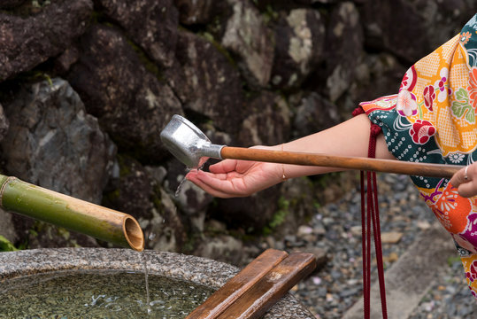 Washing hands before entering a temple in Japan